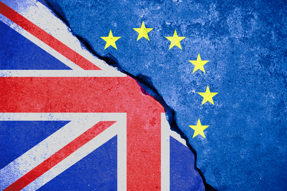 Brexit blue European Union EU flag on broken wall and half Great Britain flag