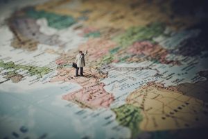Mini figure standing on map of Europe