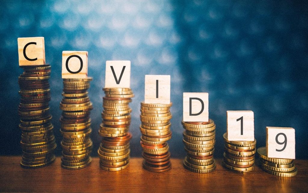 Pile of coins with COVID letters over