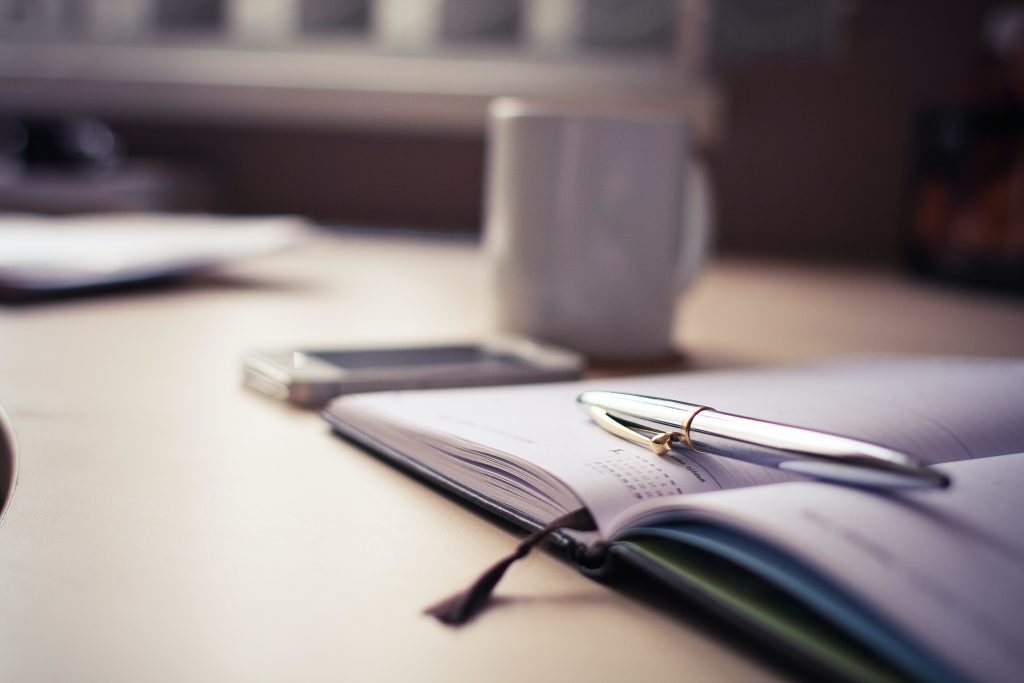 Silver pen resting on an open diary