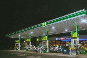 Distant view of a petrol station lit up a night