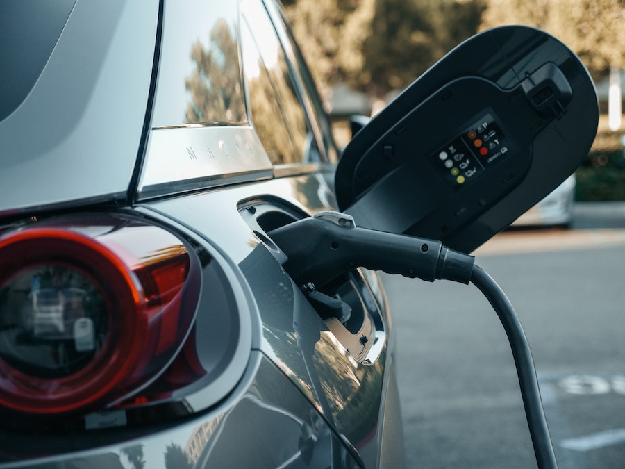 A grey electric car at a charging point